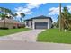 Charming single-Gathering home boasting a well-manicured lawn and attractive brick paver driveway at 280 Antis Dr, Rotonda West, FL 33947