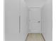 Hallway featuring white closet with minimalist handle design and tile floor at 280 Antis Dr, Rotonda West, FL 33947