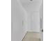 Hallway featuring white closet with minimalist handle design and tile floor at 280 Antis Dr, Rotonda West, FL 33947