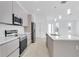 Bright kitchen with modern appliances and a large island perfect for entertaining at 280 Antis Dr, Rotonda West, FL 33947