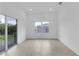 Spacious living room with access to the patio and plenty of natural light from the surrounding landscape at 280 Antis Dr, Rotonda West, FL 33947