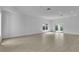 Expansive living room with tile flooring, natural lighting, and sliding glass door access at 280 Antis Dr, Rotonda West, FL 33947
