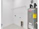 Neat utility room with a Rheem Performance water heater and a wire shelf for optimal organization and space efficiency at 280 Antis Dr, Rotonda West, FL 33947