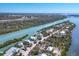 Aerial view of waterfront homes nestled along a tranquil river with lush vegetation at 310 Kettle Harbor Dr, Placida, FL 33946