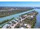 Aerial view of waterfront homes nestled along a tranquil river with lush vegetation at 310 Kettle Harbor Dr, Placida, FL 33946