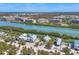 Aerial view of waterfront homes nestled along a tranquil river with lush vegetation at 310 Kettle Harbor Dr, Placida, FL 33946