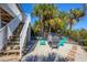 Cozy backyard seating area with gravel, chairs, and lush tropical landscaping at 310 Kettle Harbor Dr, Placida, FL 33946