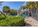A lush backyard with a pool, outdoor seating, and tropical landscaping offering a tranquil oasis at 310 Kettle Harbor Dr, Placida, FL 33946