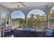 Screened lanai featuring comfortable wicker furniture and views of tropical greenery at 310 Kettle Harbor Dr, Placida, FL 33946