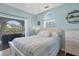 Bedroom with balcony access and a lovely view of the lush tropical foliage at 310 Kettle Harbor Dr, Placida, FL 33946