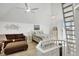 Lofted bedroom with a sitting area, a ladder, ceiling fans, and charming coastal decor at 310 Kettle Harbor Dr, Placida, FL 33946