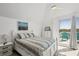 Bright bedroom with balcony access featuring scenic views and coastal decor at 310 Kettle Harbor Dr, Placida, FL 33946