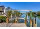 Private boat lift with waterway access surrounded by lush vegetation and serene views at 310 Kettle Harbor Dr, Placida, FL 33946