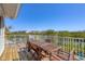 Wooden deck with dining table offering beautiful views of the surrounding landscape at 310 Kettle Harbor Dr, Placida, FL 33946