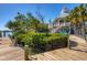Beautiful two-story home with a white exterior and a wooden dock extending into the water at 310 Kettle Harbor Dr, Placida, FL 33946