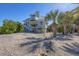 Coastal home with a cupola and staircase showcasing its elevated design and sandy surroundings at 310 Kettle Harbor Dr, Placida, FL 33946
