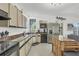 Bright kitchen with lots of cabinets, stainless steel appliances, and an island with a granite countertop at 310 Kettle Harbor Dr, Placida, FL 33946