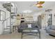 Open-concept living room with spiral staircase, comfortable seating, and seamless flow to the adjacent kitchen at 310 Kettle Harbor Dr, Placida, FL 33946