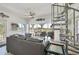Bright living room featuring a comfortable gray sofa, spiral staircase, and scenic views from large windows at 310 Kettle Harbor Dr, Placida, FL 33946