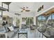 Bright living room featuring a comfortable sofa, swivel chairs, and a sliding glass door with views of the greenery at 310 Kettle Harbor Dr, Placida, FL 33946