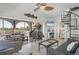 Open living room with a spiral staircase, comfortable seating, and seamless access to a screened outdoor dining area at 310 Kettle Harbor Dr, Placida, FL 33946