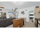 View of a versatile living area featuring an island, spiral staircase, and an adjacent living room and bathroom at 310 Kettle Harbor Dr, Placida, FL 33946