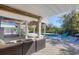Outdoor living space featuring a pool, lounging area, and beautiful tropical landscaping at 310 Kettle Harbor Dr, Placida, FL 33946