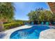Private pool surrounded by lush landscaping, offering a relaxing retreat with ample seating and sunshine at 310 Kettle Harbor Dr, Placida, FL 33946