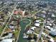 A stunning aerial view of waterfront homes situated along picturesque canals surrounded by lush tropical vegetation at 408 S Mccall Rd, Englewood, FL 34223