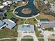 Aerial view of a home with water access, mature landscaping, and a pool in the community at 408 S Mccall Rd, Englewood, FL 34223