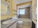 Bathroom featuring tiled shower and tub with safety grab bars, and a single sink vanity at 408 S Mccall Rd, Englewood, FL 34223