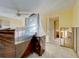Renovated bedroom with unfinished walls, ceiling fan and ensuite bathroom at 408 S Mccall Rd, Englewood, FL 34223