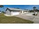 Well-maintained single-story home featuring an attached two-car garage and a paved driveway at 408 S Mccall Rd, Englewood, FL 34223
