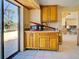 Incomplete kitchen with tile floor, unfinished walls, and wood cabinets next to sliding glass door at 408 S Mccall Rd, Englewood, FL 34223