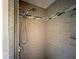 Upgraded shower with neutral tile and glass shelving at 408 S Mccall Rd, Englewood, FL 34223