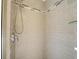 Shower featuring grey tile and glass shelving at 408 S Mccall Rd, Englewood, FL 34223
