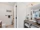 Bright bathroom features a tiled floor, modern vanity, and an open door to the shower, adding convenience at 4410 Warren Ave # 217, Port Charlotte, FL 33953