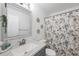 Clean bathroom features a decorative mirror, framed wall decor, and stylish shower curtain at 4410 Warren Ave # 217, Port Charlotte, FL 33953