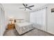 Cozy bedroom with a ceiling fan, soft carpet, and natural light streaming through the sheer curtains at 4410 Warren Ave # 217, Port Charlotte, FL 33953