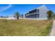 Beautiful gray building with a well-maintained lawn and lush landscaping at 4410 Warren Ave # 217, Port Charlotte, FL 33953