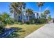 Inviting condo complex with tropical landscaping, light blue painted siding, and charming outdoor spaces at 4410 Warren Ave # 217, Port Charlotte, FL 33953