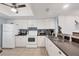 Well-lit kitchen boasts white cabinets, tiled floors, and a sleek countertop with modern appliances for cooking at 4410 Warren Ave # 217, Port Charlotte, FL 33953