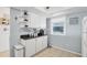 Bright kitchen area boasts white cabinets, modern appliances, and a window, with stylish decor at 4410 Warren Ave # 217, Port Charlotte, FL 33953