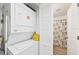 Convenient laundry area with stacked washer and dryer, and a door to the bathroom at 4410 Warren Ave # 217, Port Charlotte, FL 33953