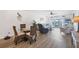Inviting living and dining areas featuring wood floors, stylish furniture, and tranquil water views from balcony at 4410 Warren Ave # 217, Port Charlotte, FL 33953