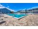 Inviting community pool with clear blue water next to blue apartment buildings on a sunny day at 4410 Warren Ave # 217, Port Charlotte, FL 33953