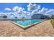 Community pool featuring clear blue water with lounge chairs surrounding the pool and blue apartment buildings in the background at 4410 Warren Ave # 217, Port Charlotte, FL 33953