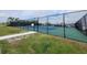 This property includes access to a fenced in, well-maintained tennis court with green and blue surface at 4410 Warren Ave # 217, Port Charlotte, FL 33953