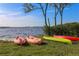 Waterfront view featuring colorful kayaks resting on the grassy shore near the water at 4410 Warren Ave # 217, Port Charlotte, FL 33953