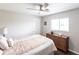 Bright bedroom with a ceiling fan, wood floors, and a dresser beneath the window at 52 Mariner Ln, Rotonda West, FL 33947